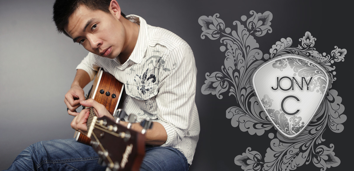 Jony C sitting with a guitar